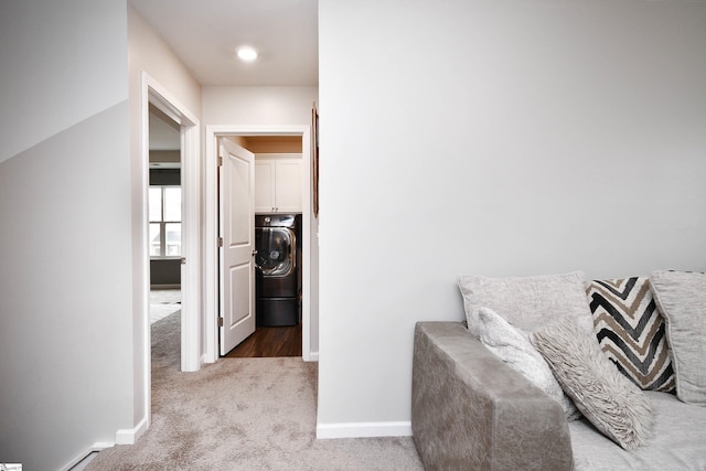 corridor with carpet floors and washer / clothes dryer