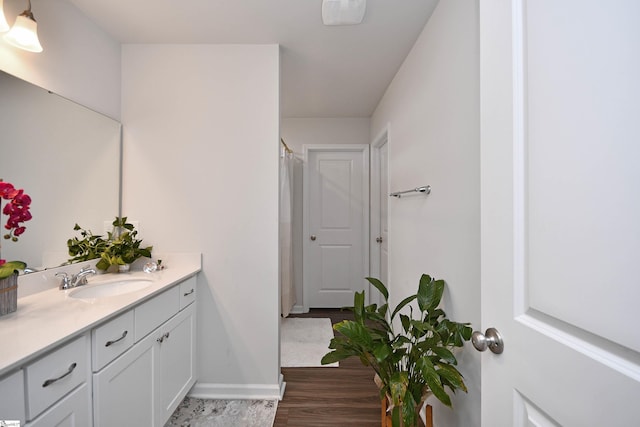 bathroom with vanity and wood-type flooring