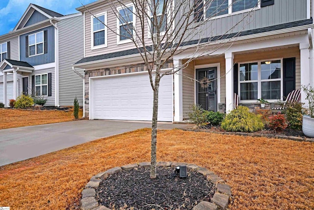 view of front of property featuring a front yard and a garage