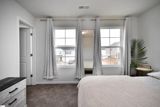 bedroom with dark colored carpet