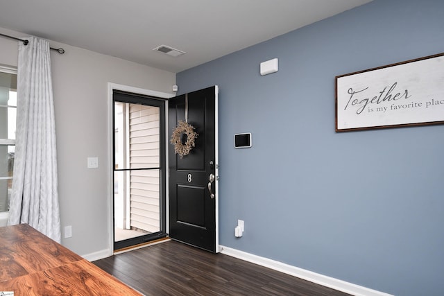 foyer with dark hardwood / wood-style floors