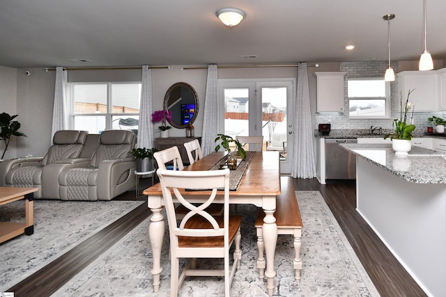 dining space with sink, dark wood-type flooring, and french doors