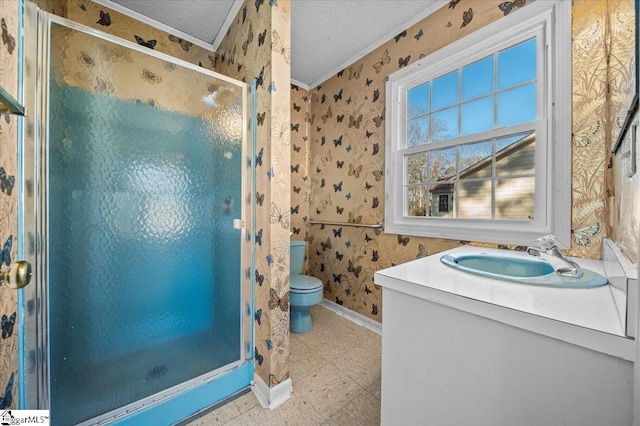 bathroom featuring vanity, a textured ceiling, crown molding, toilet, and a shower with shower door