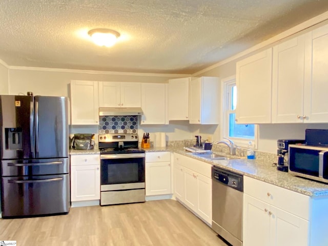 kitchen featuring sink, appliances with stainless steel finishes, crown molding, white cabinets, and light wood-type flooring