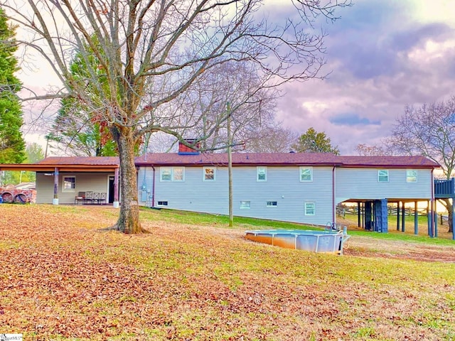 rear view of house with a yard