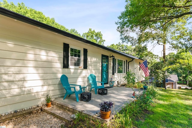 back of property featuring a yard and a patio