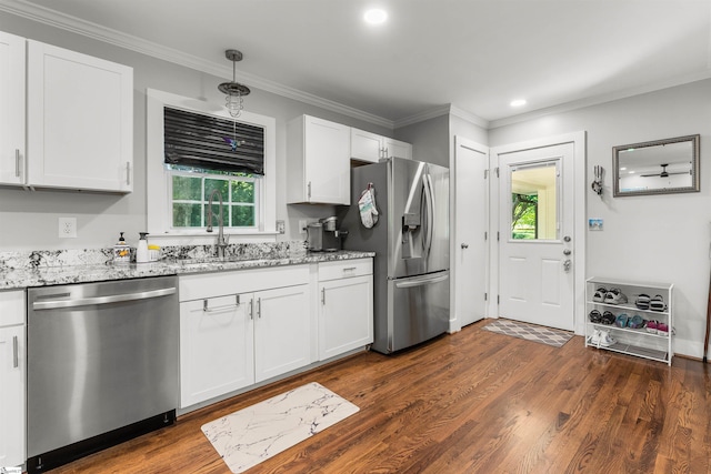 kitchen featuring light stone countertops, appliances with stainless steel finishes, dark hardwood / wood-style flooring, sink, and white cabinetry