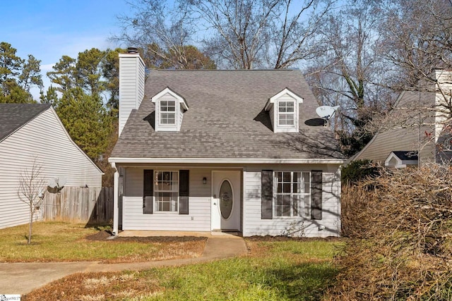 cape cod home featuring a front yard and a porch