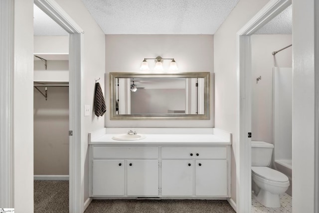 full bathroom with vanity, toilet, and a textured ceiling