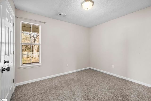 unfurnished room featuring carpet flooring and a textured ceiling