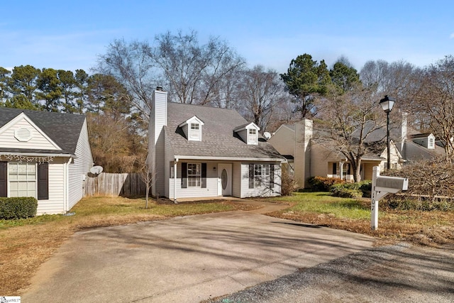 cape cod house with a front yard