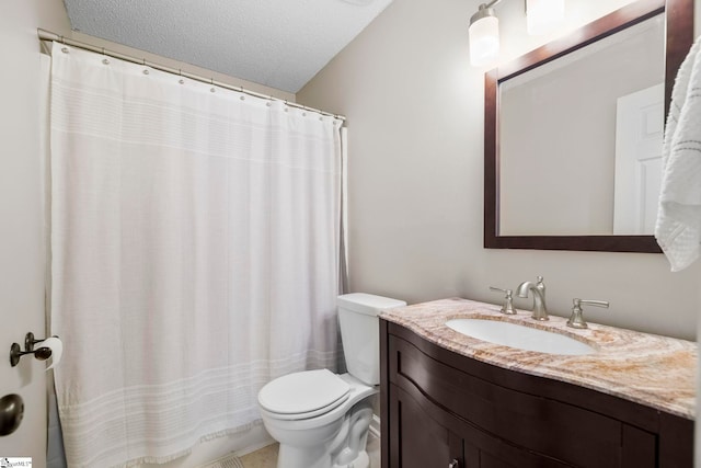 bathroom with vanity, a textured ceiling, and toilet