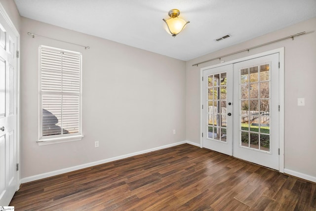 spare room with french doors and dark hardwood / wood-style floors