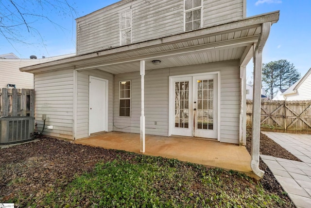 rear view of house featuring french doors, a patio area, and central air condition unit