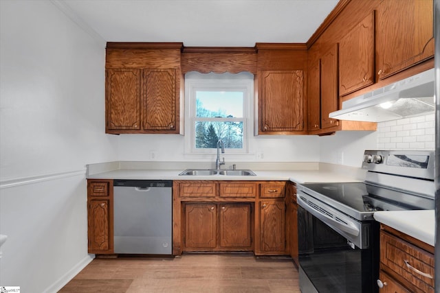 kitchen featuring appliances with stainless steel finishes, light wood-type flooring, and sink