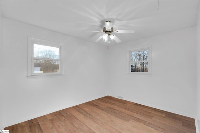 spare room featuring light wood-type flooring and ceiling fan