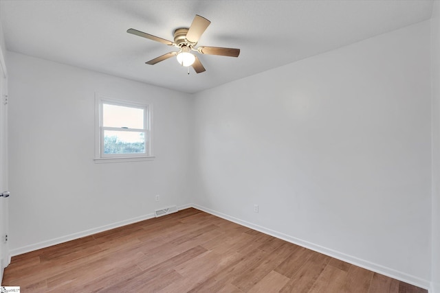 spare room with light hardwood / wood-style floors and ceiling fan