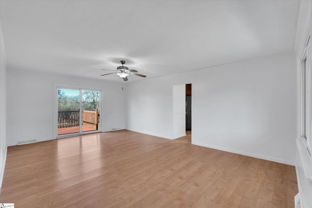 empty room featuring ceiling fan and light hardwood / wood-style floors