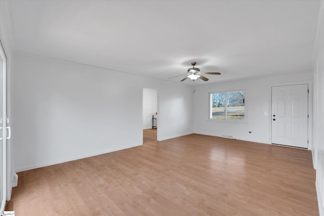 spare room featuring ceiling fan and light hardwood / wood-style flooring