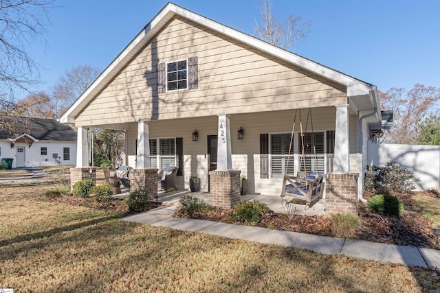 view of front of home featuring a porch and a front lawn