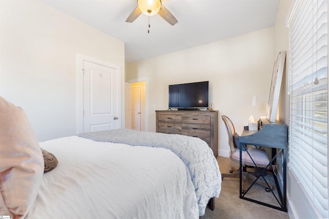 carpeted bedroom featuring multiple windows and ceiling fan