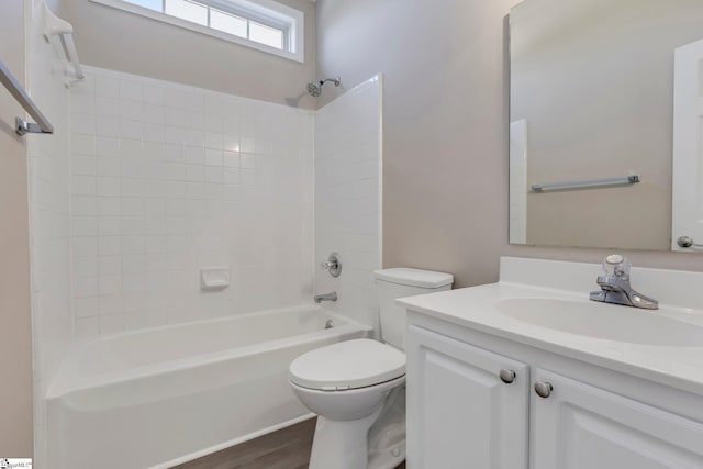 full bathroom featuring vanity, toilet, wood-type flooring, and bathtub / shower combination