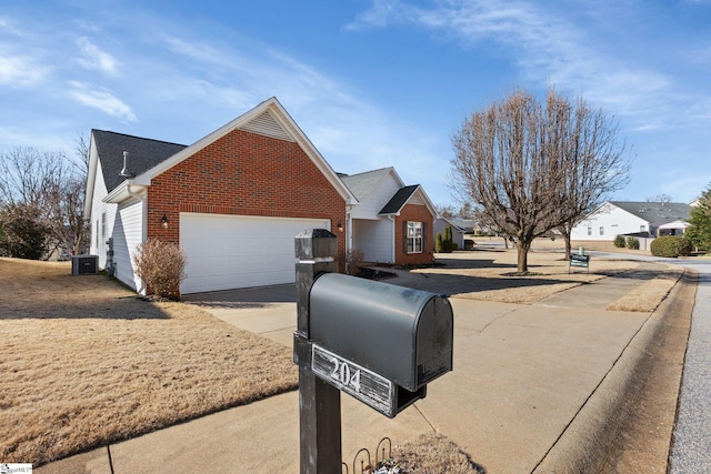 view of front of house with central AC unit and a garage