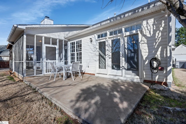 rear view of house featuring a patio area, a sunroom, and cooling unit