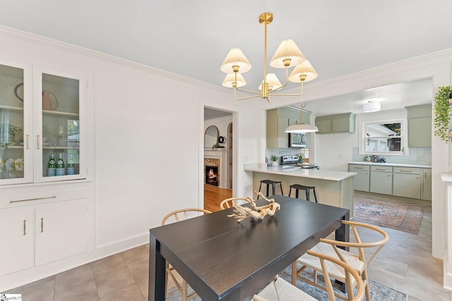 dining space with light tile patterned floors, crown molding, and a notable chandelier