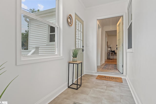 entryway featuring light tile patterned floors and crown molding