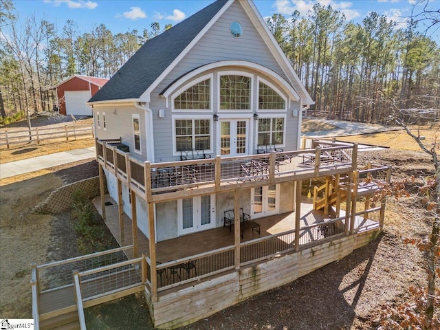 rear view of property featuring a wooden deck and french doors