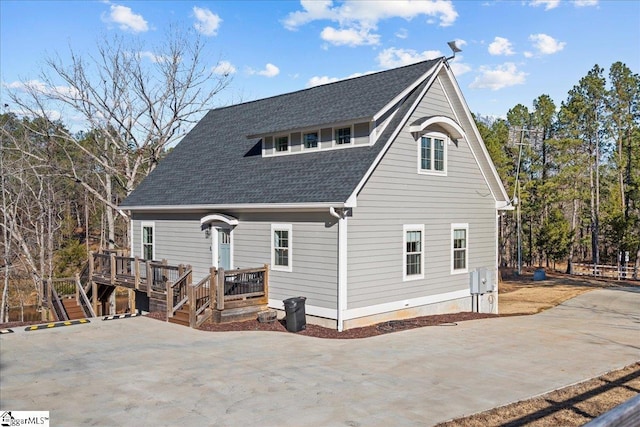 rear view of house with a wooden deck