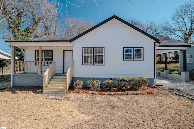 view of front of home with a porch and a carport