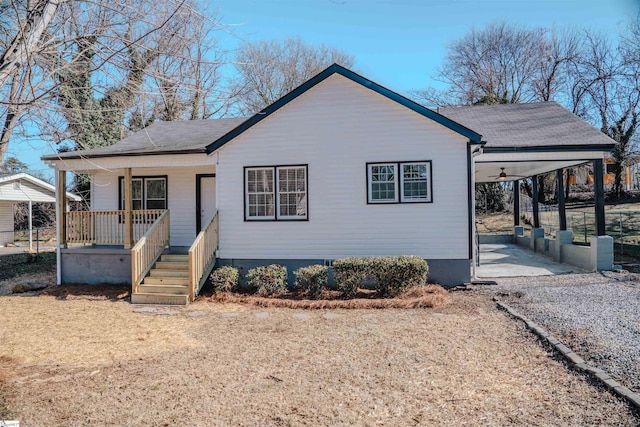 view of front of home with ceiling fan, covered porch, and a carport