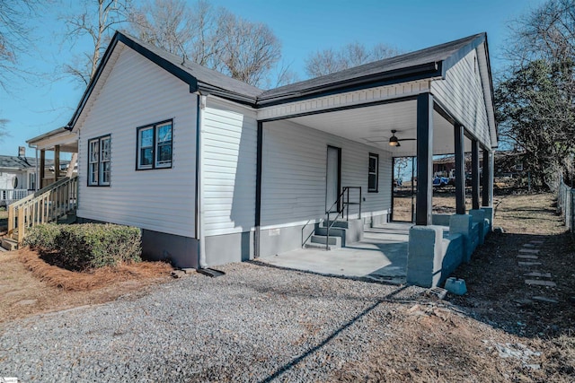 view of property exterior with a porch and ceiling fan