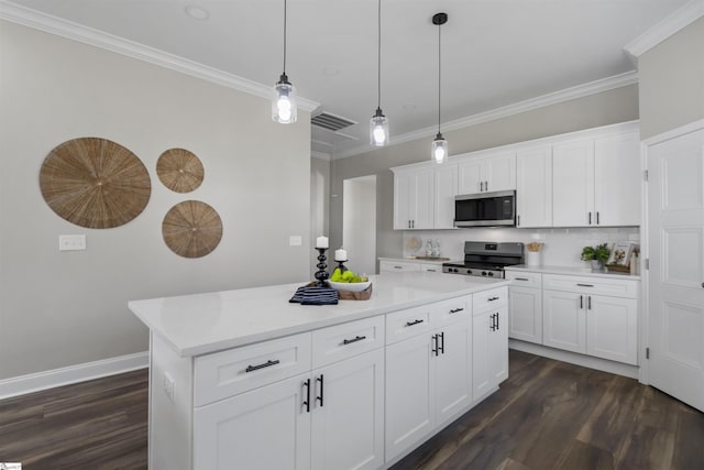 kitchen with a center island, black range oven, crown molding, decorative light fixtures, and white cabinetry