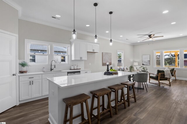 kitchen featuring a center island, sink, and white cabinets