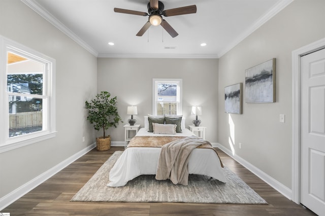 bedroom with multiple windows, dark hardwood / wood-style flooring, and ceiling fan