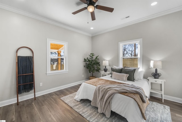 bedroom featuring ceiling fan, dark hardwood / wood-style floors, and ornamental molding