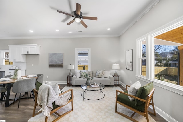 living room featuring crown molding and ceiling fan