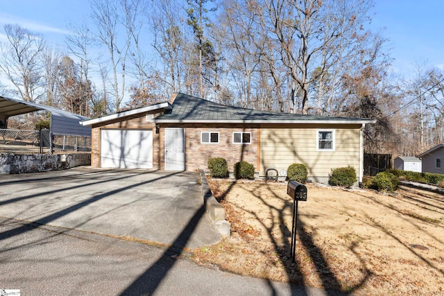 view of front facade featuring a garage and a carport