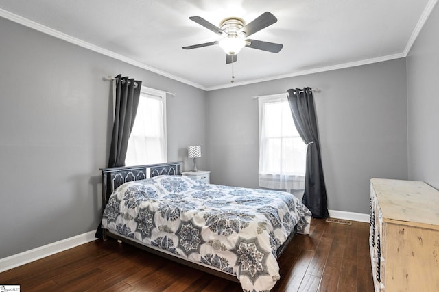 bedroom with multiple windows, ceiling fan, crown molding, and dark hardwood / wood-style floors