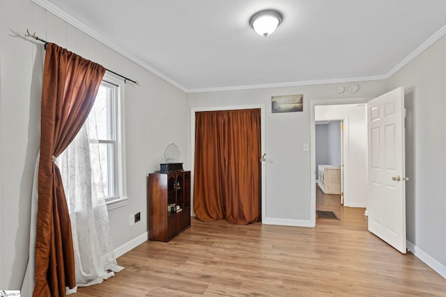 bedroom featuring crown molding and light hardwood / wood-style flooring