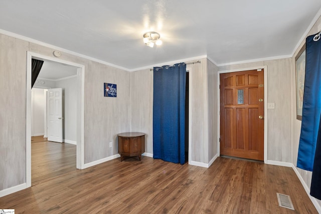 entrance foyer featuring dark hardwood / wood-style flooring and ornamental molding