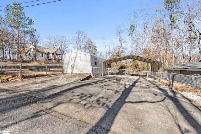 view of side of property with a carport and a shed