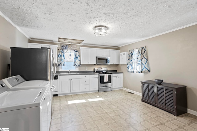 kitchen featuring white cabinetry, sink, separate washer and dryer, and stainless steel appliances