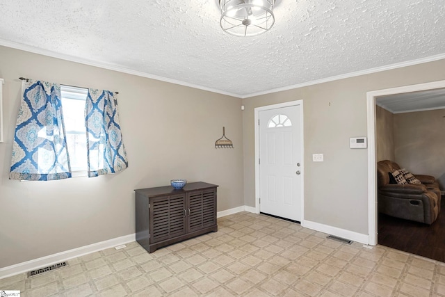 entryway with a textured ceiling and crown molding