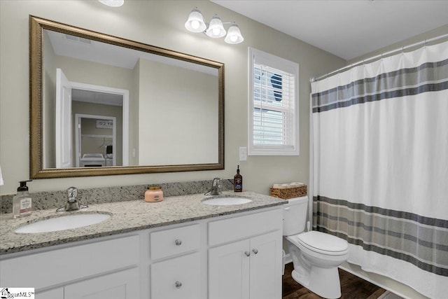 bathroom with toilet, vanity, a shower with shower curtain, and hardwood / wood-style flooring