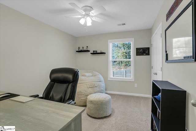 carpeted home office with ceiling fan