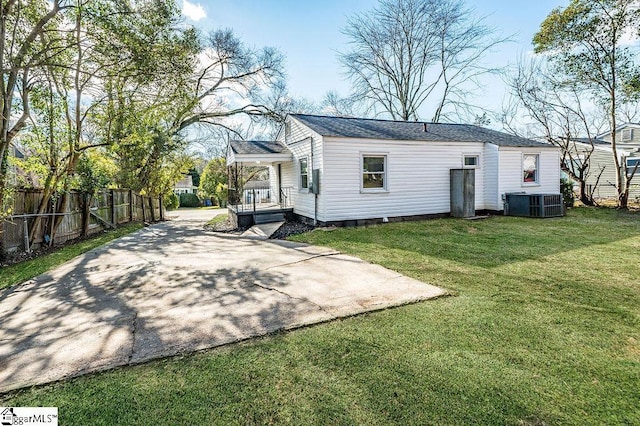 back of property with a yard and cooling unit